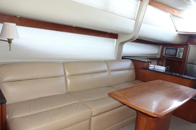 Slide: The Image of Luxurious interior of 2007 Meridian 459 yacht with leather sofa and wooden table. - 87