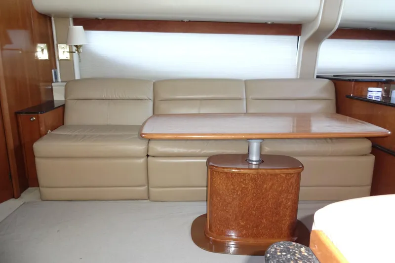 Slide: The Image of Luxurious interior of 2007 Meridian 459 yacht with beige leather seating and wooden table. - 88