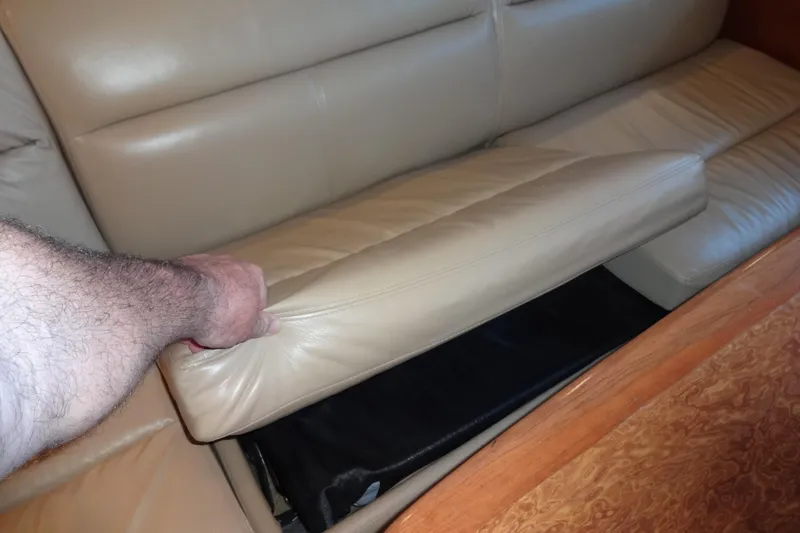 Slide: The Image of Hand lifting cushion on 2007 Meridian 459 yacht's beige leather sofa. - 91