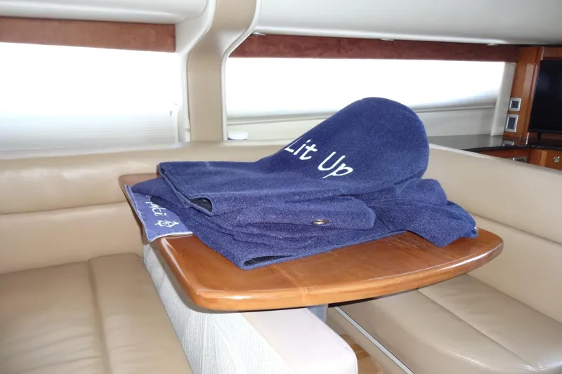 Slide: The Image of Luxurious interior of 2007 Meridian 459 yacht with blue fender covers on wooden dinette table. - 93