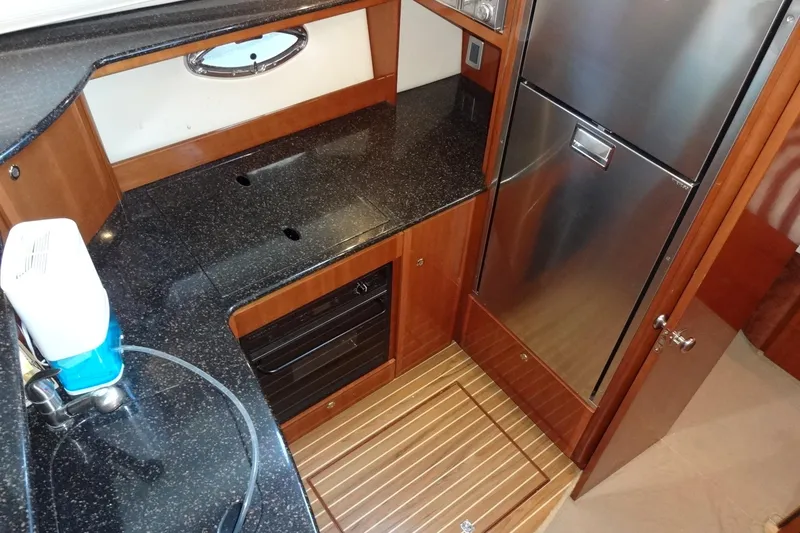 Slide: The Image of Luxurious 2007 Meridian 459 yacht galley with sleek countertops and stainless-steel appliances. - 94