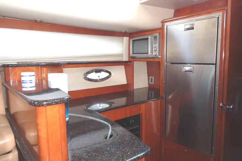 Slide: The Image of Luxurious 2007 Meridian 459 yacht kitchen with modern appliances and elegant wood finish. - 97