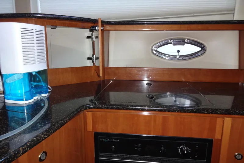 Slide: The Image of 2007 Meridian 459 yacht kitchen with sleek countertops and modern appliances. - 99