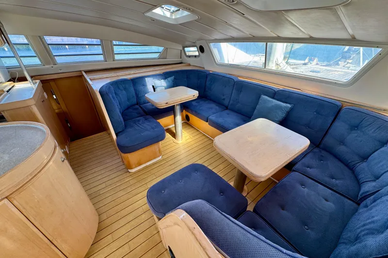 Slide: The Image of Luxurious 1992 Wauquiez Kronos yacht interior with blue seating and wooden accents. - 13