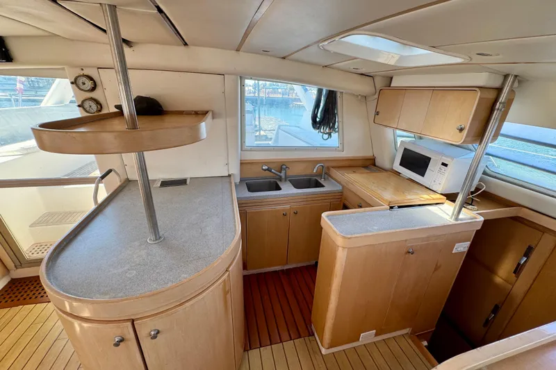 Slide: The Image of Interior of 1992 Wauquiez Kronos yacht kitchen with wooden cabinetry and modern appliances. - 14