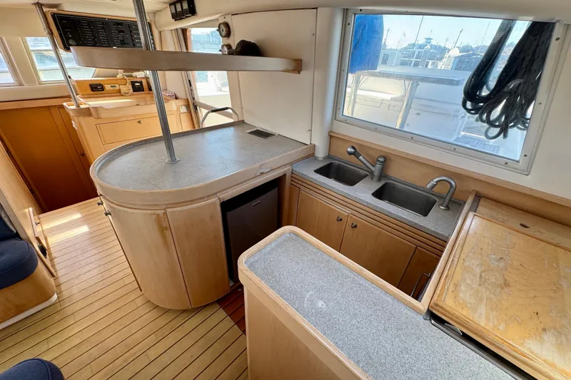 Slide: The Image of Interior of 1992 Wauquiez Kronos yacht with modern kitchen and wooden cabinetry. - 16