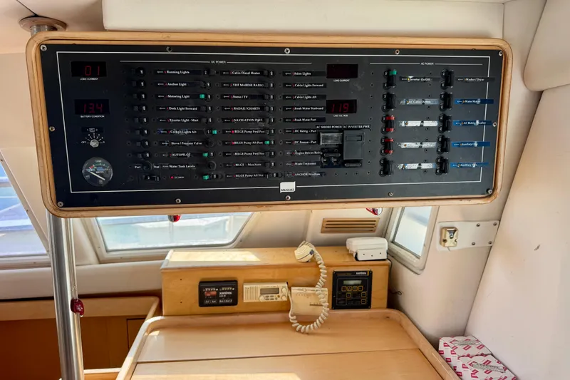 Slide: The Image of Control panel inside 1992 Wauquiez Kronos yacht, featuring various switches and gauges. - 17