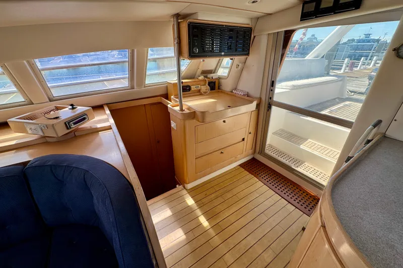 Slide: The Image of Interior of 1992 Wauquiez Kronos yacht with wooden flooring and navigation equipment. - 18