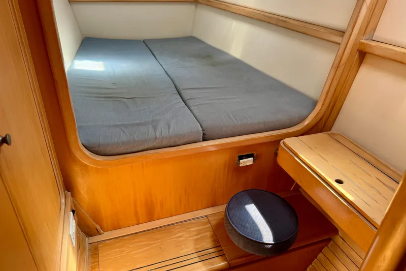 Slide: The Image of Cozy cabin interior of 1992 Wauquiez Kronos sailboat with wooden furnishings and a cushioned bed. - 20