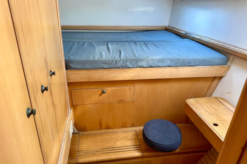 Slide: The Image of Cozy cabin interior of 1992 Wauquiez Kronos sailboat with wooden furnishings and blue mattress. - 23