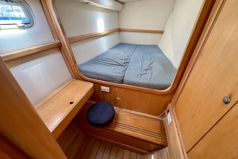 Slide: The Image of Cozy cabin interior of 1992 Wauquiez Kronos sailboat with wooden furnishings and bed. - 27