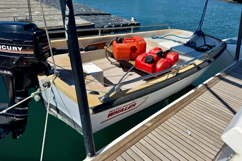 Slide: The Image of Small boat with Mercury outboard motor docked, featuring fuel containers on deck. - 29