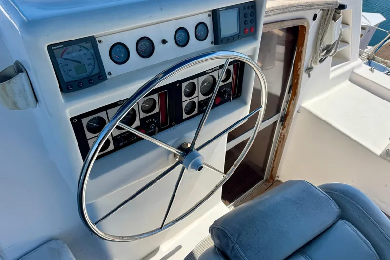 Slide: The Image of 1992 Wauquiez Kronos yacht helm with steering wheel and navigation instruments. - 6