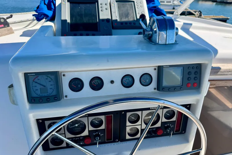 Slide: The Image of 1992 Wauquiez Kronos yacht dashboard with navigation instruments and steering wheel. - 7