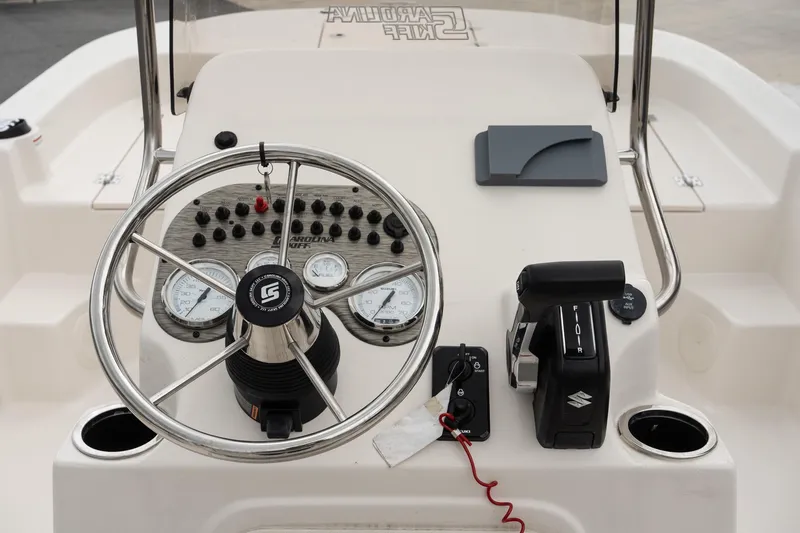 Slide: The Image of 2025 Carolina Skiff 19 LS boat console with steering wheel and controls. - 11