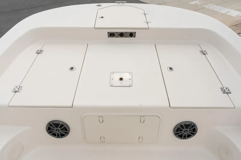 Slide: The Image of 2025 Carolina Skiff 19 LS boat deck with storage compartments and speakers. - 14