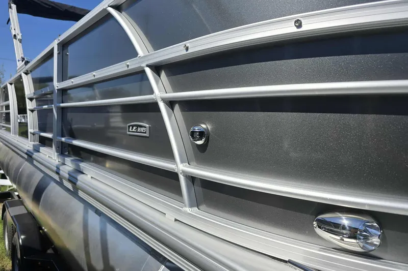 Slide: The Image of 2026 Trifecta 24ULLET275 pontoon boat with sleek metallic exterior and LE Series badge. - 10