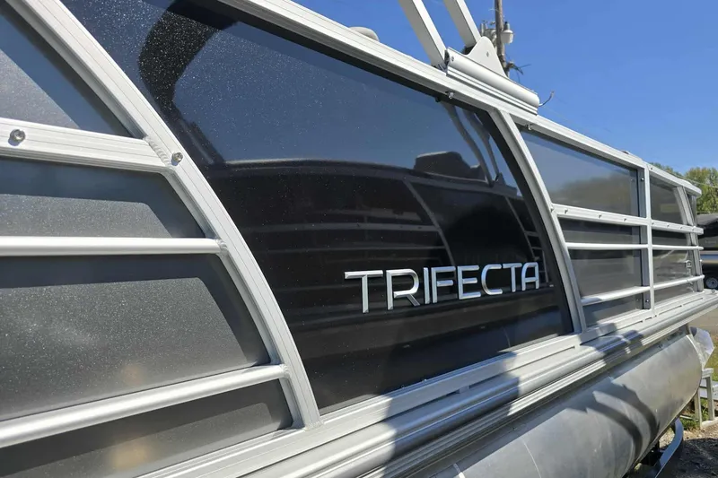 Slide: The Image of 2026 Trifecta 24ULLET275 pontoon boat with sleek design and metallic finish. - 3