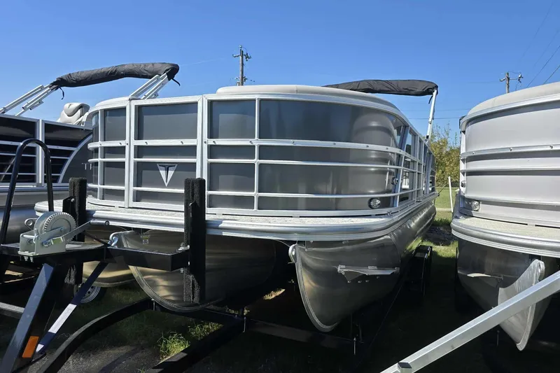 Slide: The Image of 2026 Trifecta 24ULLET275 pontoon boat on trailer, sunny day, front view. - 4