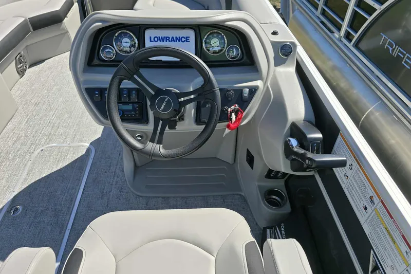 Slide: The Image of 2026 Trifecta 24ULLET275 boat dashboard with steering wheel and Lowrance display. - 7