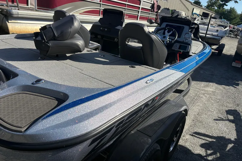 The Image of 2024 Nitro Z19 Pro boat on trailer, parked on a driveway, surrounded by greenery. - 0