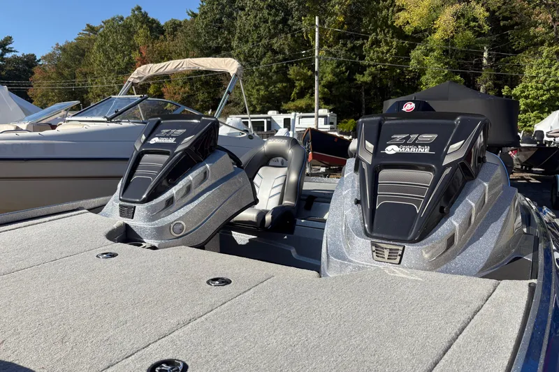 Slide: The Image of 2024 Nitro Z19 Pro boat with sleek design, parked outdoors, surrounded by trees and other boats. - 7