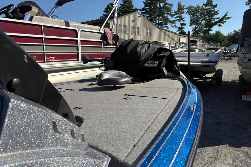 Slide: The Image of 2024 Nitro Z19 Pro boat with blue accents, parked outdoors near other boats. - 9