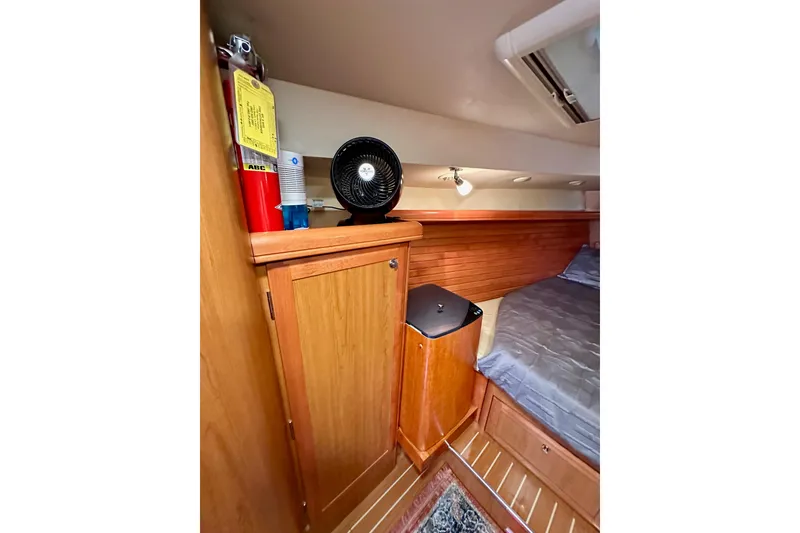 Slide: The Image of Cozy cabin interior of 2008 Hunter 49 yacht with wooden cabinetry and bed. - 101