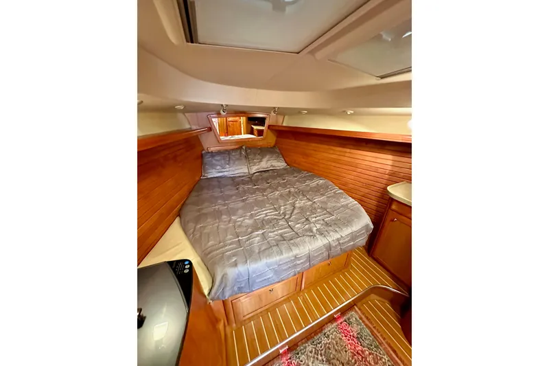 Slide: The Image of Luxurious cabin interior of 2008 Hunter 49 yacht with cozy bed and wooden finish. - 103