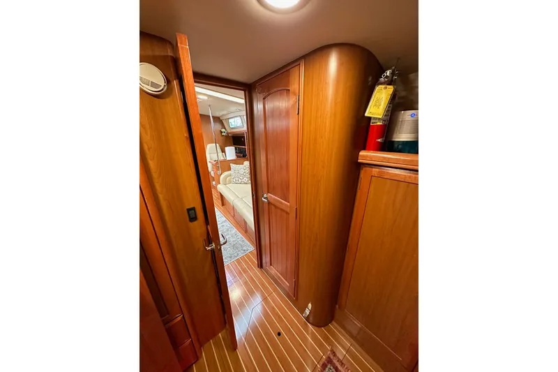 Slide: The Image of Interior of 2008 Hunter 49 yacht with wooden cabinetry and cozy seating area. - 108