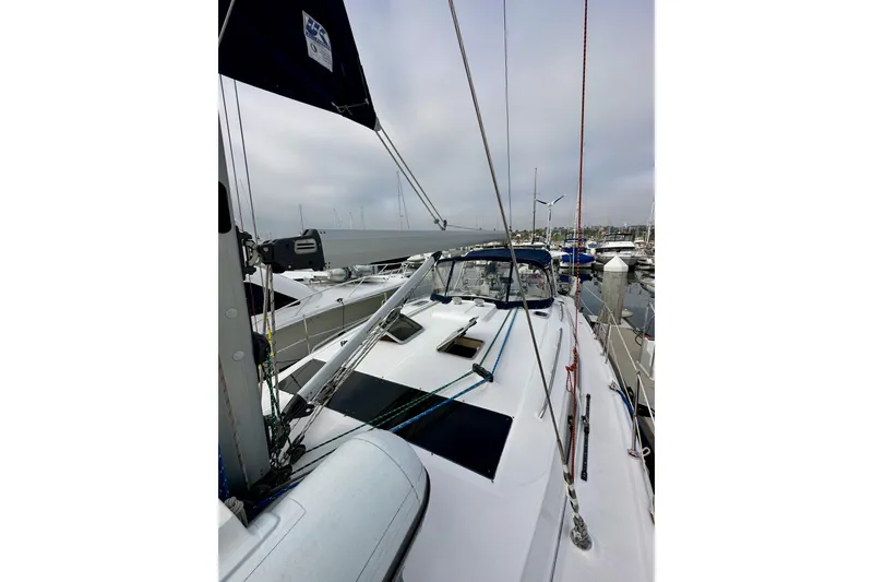 Slide: The Image of 2008 Hunter 49 sailboat docked at marina, showcasing deck and rigging. - 18