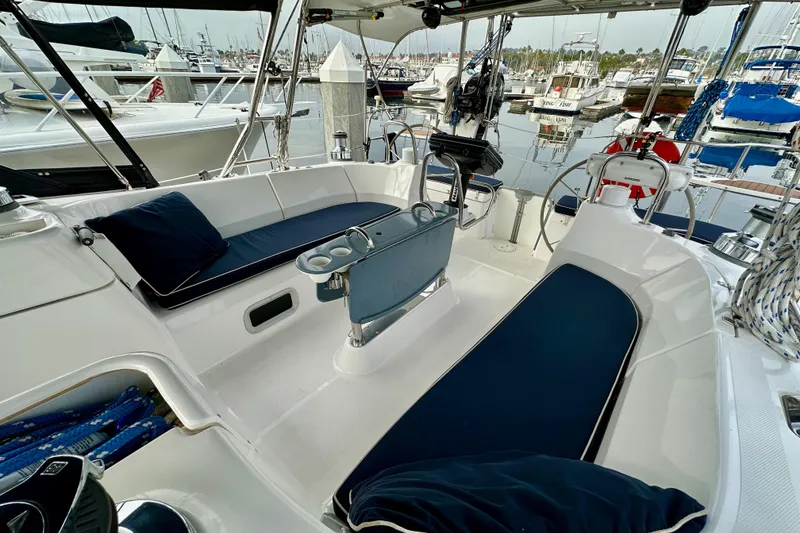 Slide: The Image of Luxurious 2008 Hunter 49 yacht cockpit with blue cushions, docked in a marina. - 22