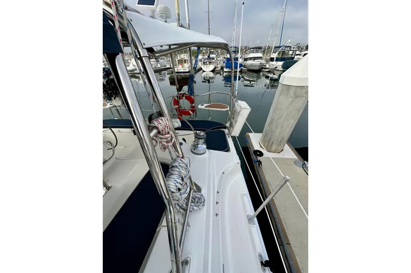 Slide: The Image of 2008 Hunter 49 sailboat docked at marina, featuring deck and rigging details. - 23