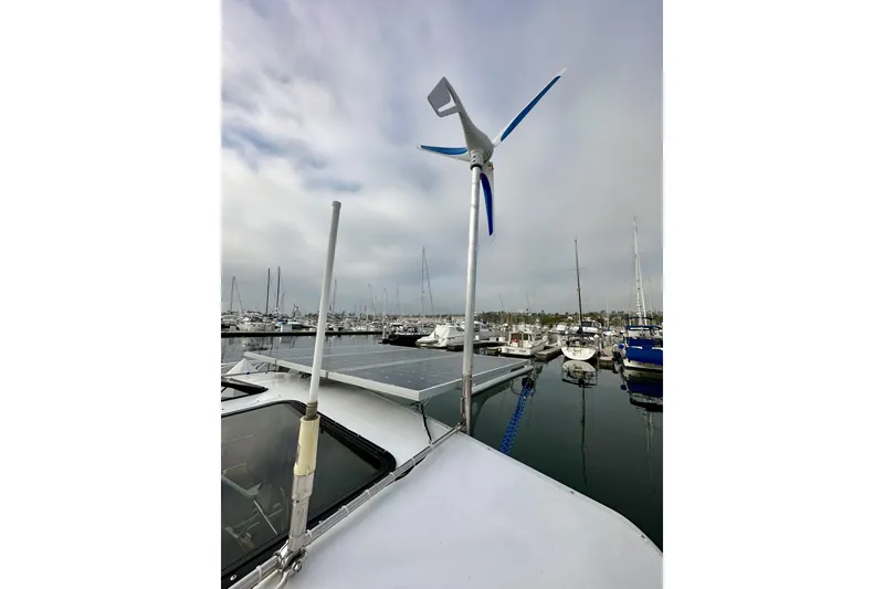 Slide: The Image of Hunter 49 sailboat (2008) with wind turbine and solar panels in marina. - 25