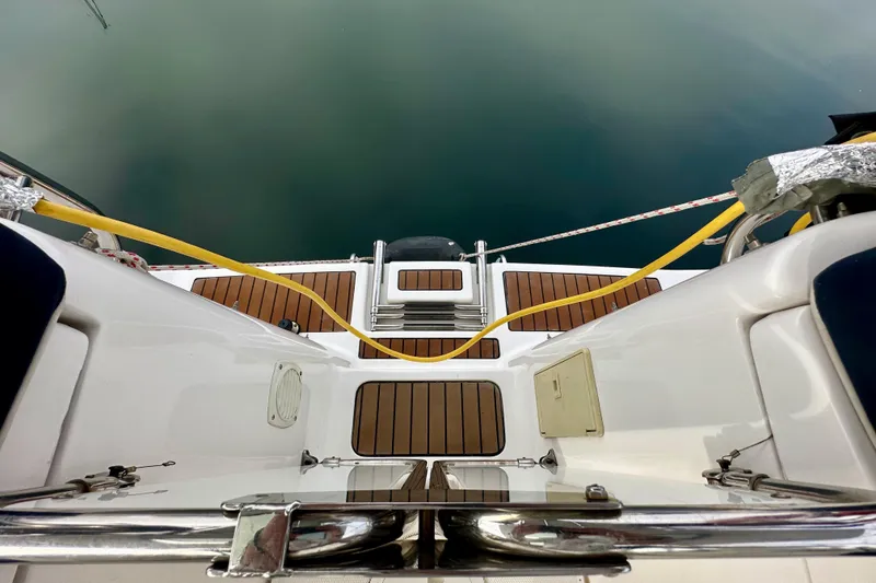 Slide: The Image of 2008 Hunter 49 yacht deck with wooden panels and mooring lines. - 29