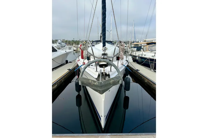 Slide: The Image of 2008 Hunter 49 sailboat docked in marina, front view with anchor and calm water. - 3