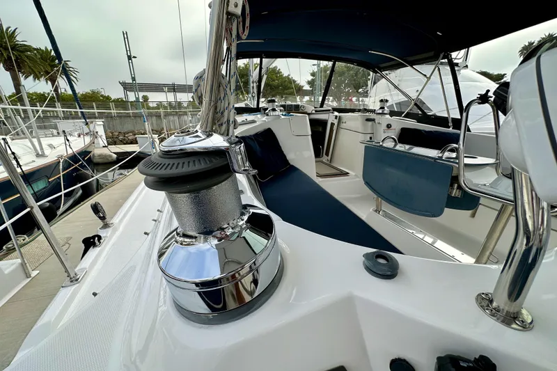 Slide: The Image of 2008 Hunter 49 sailboat cockpit with winch and seating, docked at marina. - 33