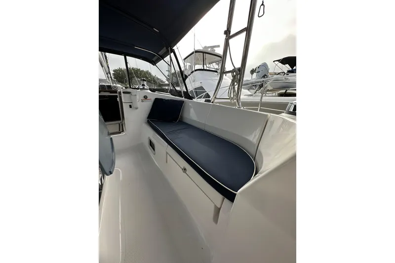 Slide: The Image of Interior view of a 2008 Hunter 49 sailboat with blue cushioned seating. - 39