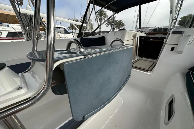 Slide: The Image of Cockpit of 2008 Hunter 49 sailboat with blue seating and stainless steel details. - 41