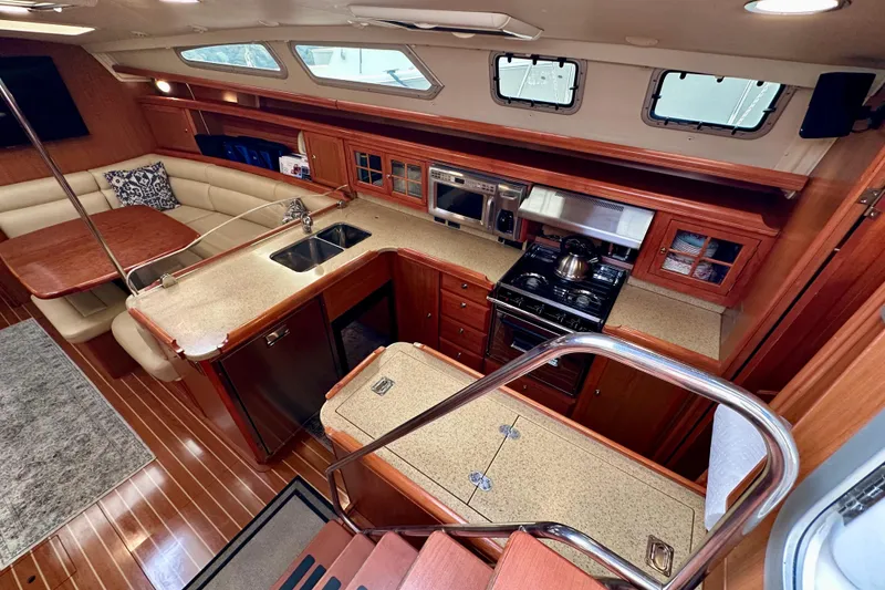 Slide: The Image of Luxurious 2008 Hunter 49 yacht interior with modern kitchen and cozy seating area. - 49