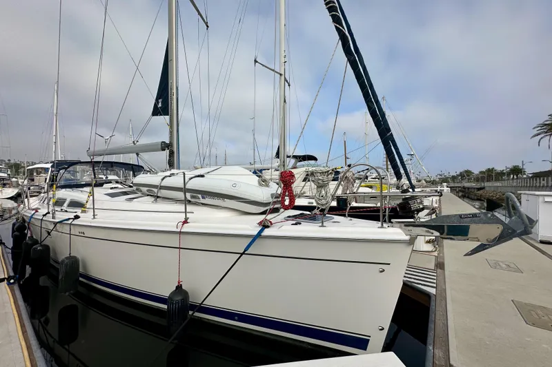 Slide: The Image of 2008 Hunter 49 sailboat docked at marina, featuring sleek design and modern rigging. - 5
