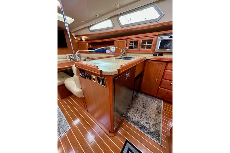 Slide: The Image of Luxurious 2008 Hunter 49 yacht interior with modern kitchen and wooden cabinetry. - 51