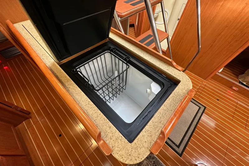 Slide: The Image of Open hatch in 2008 Hunter 49 yacht interior, revealing storage compartment. - 59