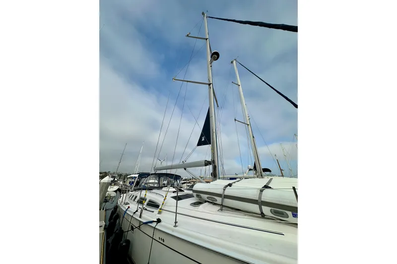 Slide: The Image of Sailboat Hunter 49, 2008 model, docked with mast and rigging visible under cloudy sky. - 6