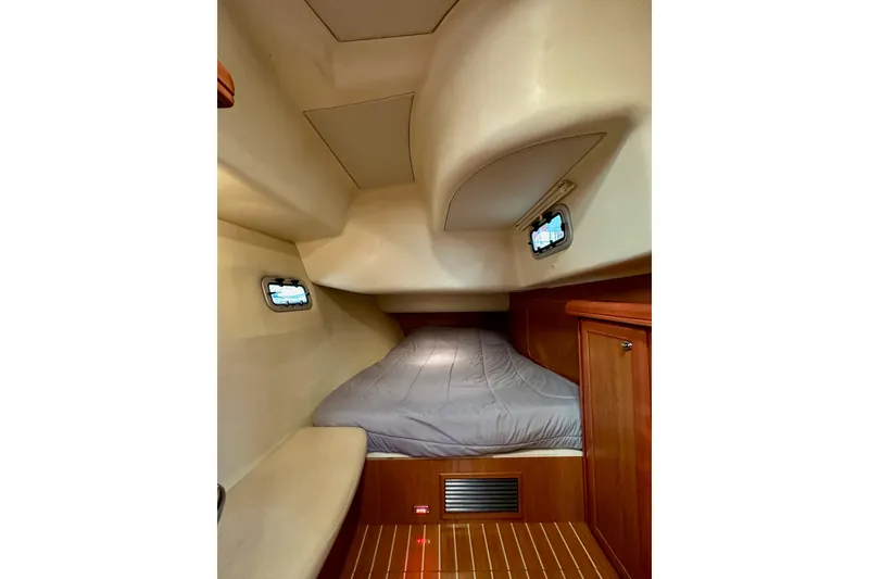 Slide: The Image of 2008 Hunter 49 yacht interior cabin with bed and wooden cabinetry. - 63