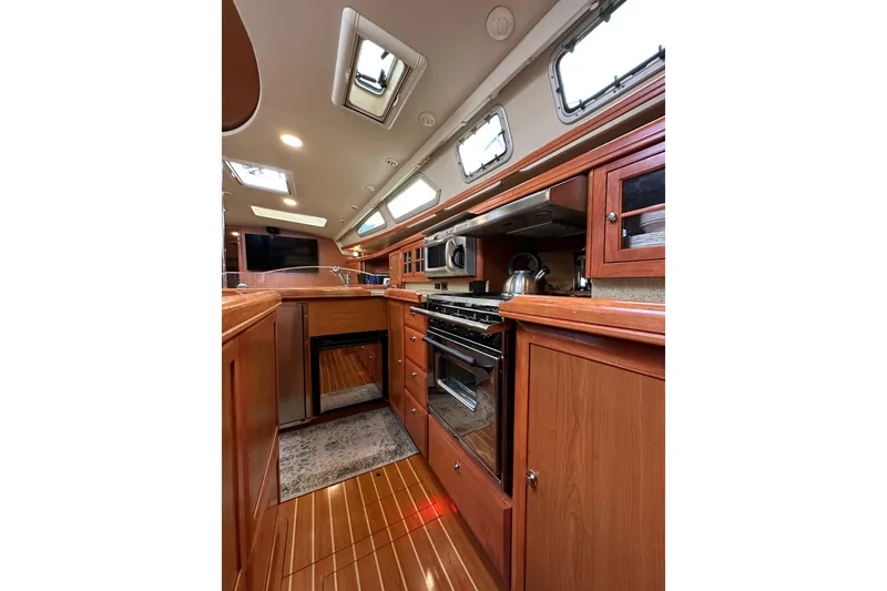 Slide: The Image of Luxurious 2008 Hunter 49 yacht interior with modern kitchen and wooden cabinetry. - 68