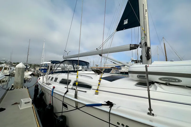 Slide: The Image of 2008 Hunter 49 sailboat docked at marina, featuring sleek design and modern rigging. - 7