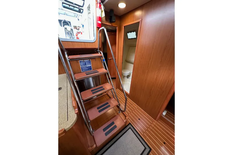 Slide: The Image of Interior of 2008 Hunter 49 yacht with wooden stairs and bathroom view. - 72