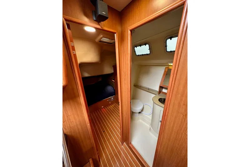 Slide: The Image of Interior of 2008 Hunter 49 yacht showing cabin and bathroom with wooden finish. - 73
