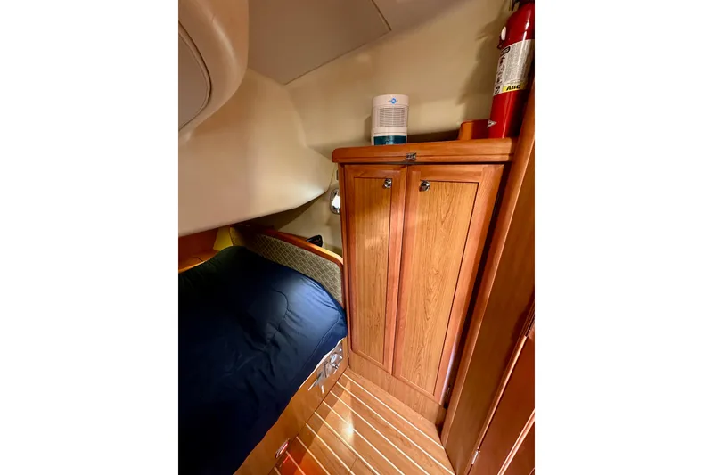 Slide: The Image of Cozy cabin interior of 2008 Hunter 49 yacht with wooden cabinetry and bedding. - 80